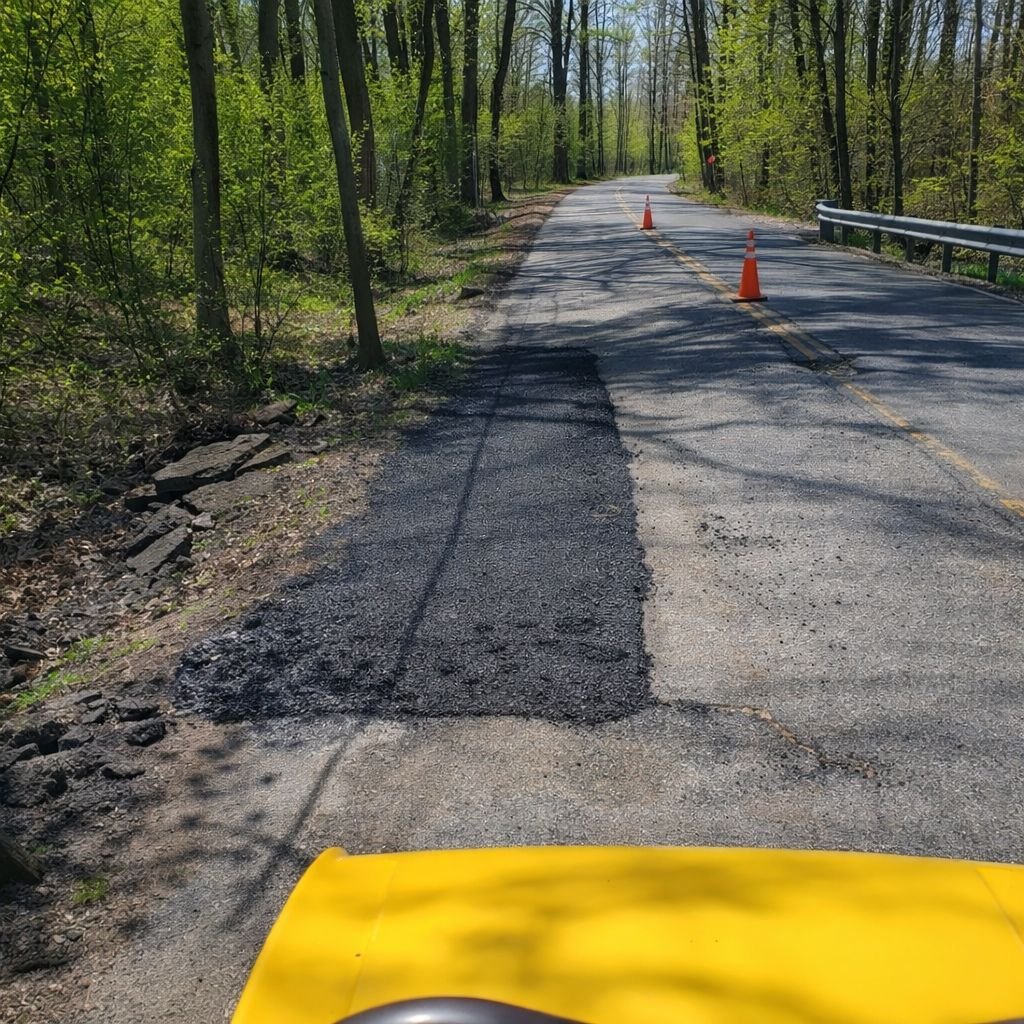 Road repair and asphalt patching on rural road in Warren County NJ